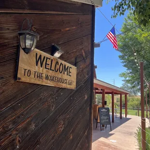 a welcome sign on the side of a building