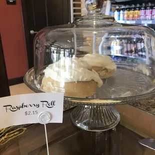 a cupcake on a glass cake stand