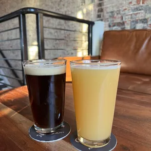 two glasses of beer on a table