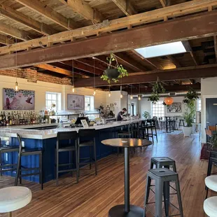 a bar with stools and tables