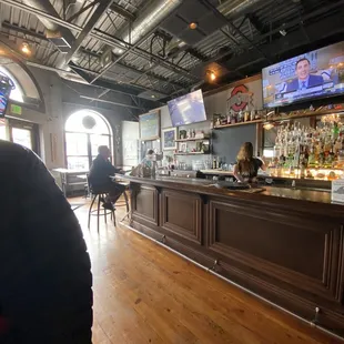 a bar with people sitting at it