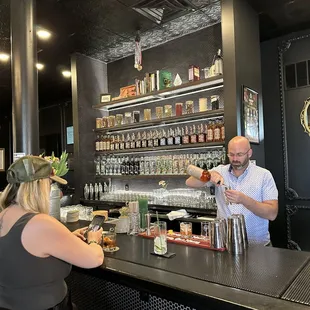 a man and a woman sitting at a bar