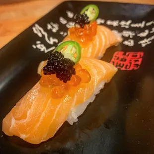 Salmon nigiri with ikura and caviar