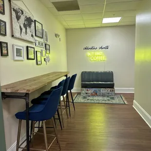 a long table with blue chairs