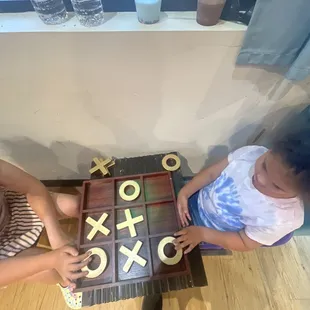 two children playing a game of ticquet