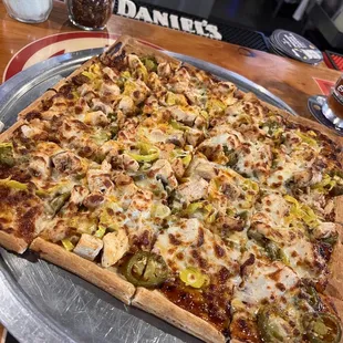a large pizza on a metal platter