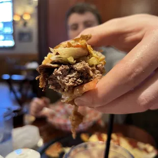 My teenager showing off his burger. He&apos;s super picky and this burger has him wanting to go back.