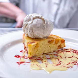 a piece of cake with ice cream on top