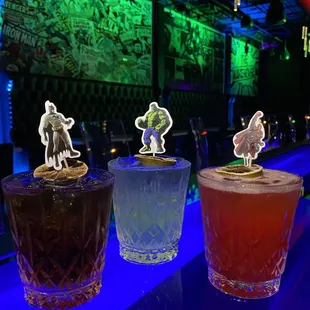 a row of cocktails on a bar