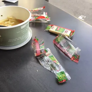 a cup of soup and packets of candy