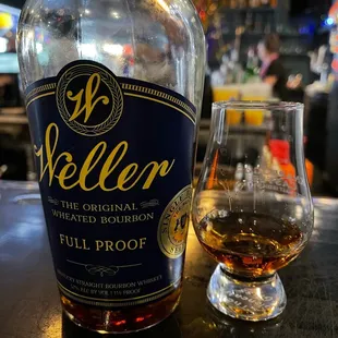 a bottle of bourbon and a glass