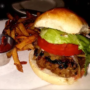 BURGER: House-ground dry-aged beef, with blue cheese and grilled onions, tomato, lettuce, medium rare, fries ($14)