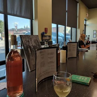 a woman sitting at a bar with a glass of wine