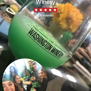 a glass of wine with a picture of a group of people in the background