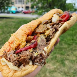 a hand holding a sandwich