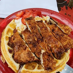 a plate of waffles with meat and vegetables