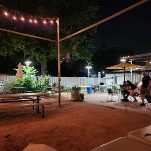 a group of people sitting at picnic tables