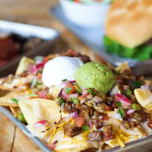 a tray of nachos and a plate of salad