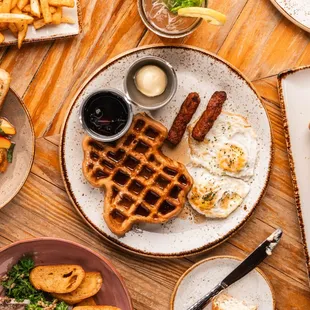 a variety of breakfast foods on a wooden table