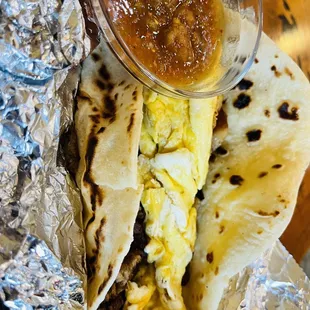 a breakfast burrito and salsa