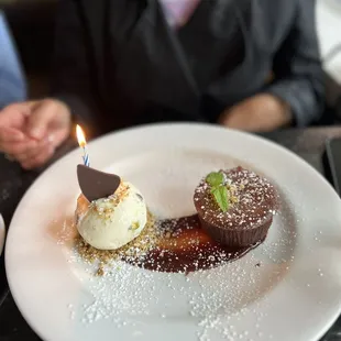 Birthday dessert - chocolate caramel molten cake with pistachio ice cream crumble