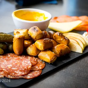 Waterfront Pub
 Soft pretzel, Tillamook white cheddar, pickles, peppadew peppers, soppressata salami, pepperoni, stone ground mustard.