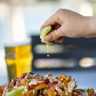 a plate of nachos and a glass of beer