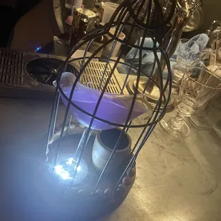 a birdcage with a light inside