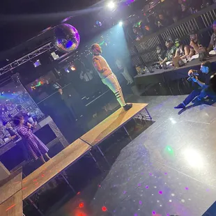 a woman standing on a stage in front of a crowd