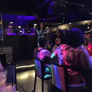 a group of people sitting at a bar