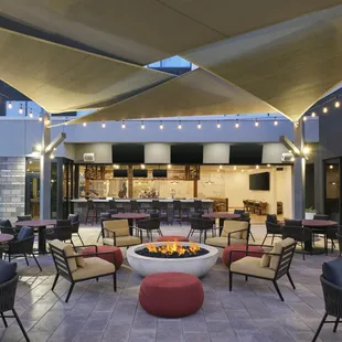 Outdoor patio with fire pit and large screen TV's
