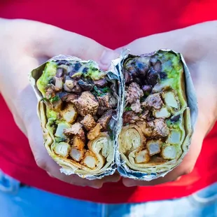 a person holding a burrito