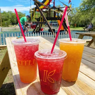 three drinks on a picnic table