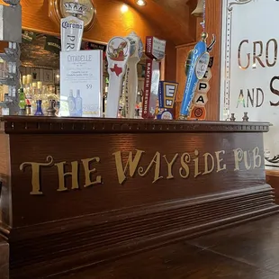 a wooden bar with beer taps