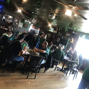 people sitting at tables in a pub