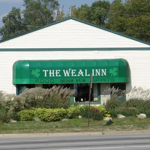 a white building with a green awning
