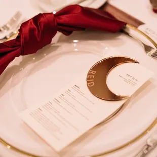 Burgundy matte satin napkins + gold rim chargers provided by The Wedding Linen Co.