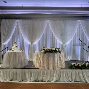 Pipe &amp; draping w/bunching accents. Cake table: blush underlay w/ivory tulle overlay. Sweetheart: ivory underlay w/blush floral overlay