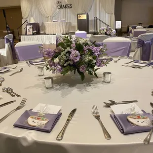 Ivory matte satin linens, dusk heather satin napkins, ivory covers w/lavender satin sashes, draping, cake &amp; sweet linens.