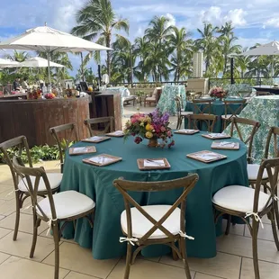 Crossback chairs, teal matte satin linens, tropical cocktail linens