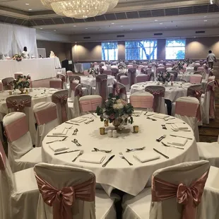Ivory covers w/mauve satin sashes, draping &amp; head table linens