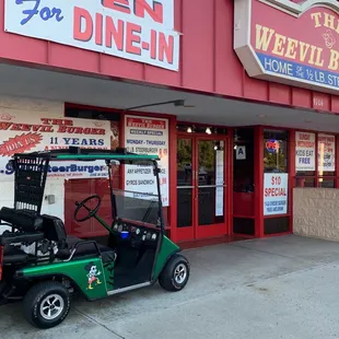 a golf cart parked in front of a restaurant