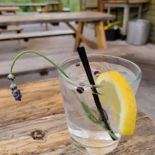 a glass of water with a lemon slice and a straw