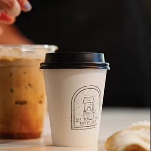 a cup of coffee and a sandwich
