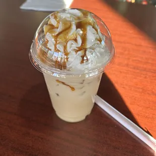 a cup of coffee with whipped cream and caramel
