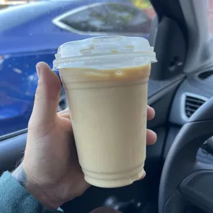 a hand holding a cup of coffee