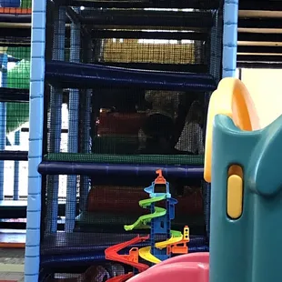 Indoor playhouse and toy bins. Lots of cars, folks and action figures. They also have a pretend kitchen area too.