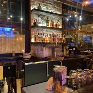 a bar with many bottles of alcohol