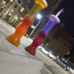 two colorful drinks on a city street