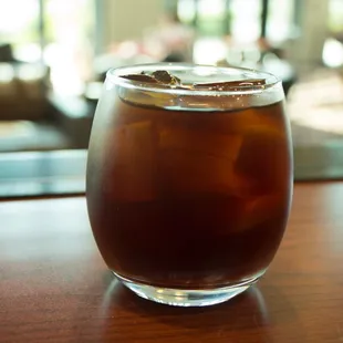 a glass of iced tea on a table